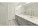 Modern bathroom showcasing double sinks, gray cabinetry, a frameless shower, and updated lighting fixtures at 5100 E Rancho Paloma Dr # 1029, Cave Creek, AZ 85331