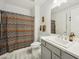 Bright bathroom featuring white vanity, patterned shower curtain and gray tile flooring at 5100 E Rancho Paloma Dr # 1029, Cave Creek, AZ 85331