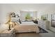 Bright bedroom featuring a plush bed, stylish furniture, and a window offering a view of natural outdoor scenery at 5100 E Rancho Paloma Dr # 1029, Cave Creek, AZ 85331