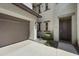 Home exterior with two-car garage, neutral stucco, and stone accents around the front door at 5100 E Rancho Paloma Dr # 1029, Cave Creek, AZ 85331