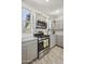 Kitchen with stainless steel appliances, light gray cabinets, and tiled floor at 5100 E Rancho Paloma Dr # 1029, Cave Creek, AZ 85331