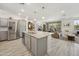 Kitchen with island, stainless steel appliances, and hardwood floors leading to living area at 5100 E Rancho Paloma Dr # 1029, Cave Creek, AZ 85331