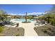 Community pool area featuring desert landscaping, shaded seating, and lounge chairs at 5100 E Rancho Paloma Dr # 1029, Cave Creek, AZ 85331
