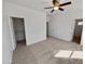 This bedroom has carpet floors, a ceiling fan, and ample closet space with an ensuite bathroom at 5339 W Maldonado Rd, Laveen, AZ 85339