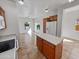 Bright eat-in kitchen featuring wood cabinets, a center island, and ample counter space for cooking and entertaining at 5339 W Maldonado Rd, Laveen, AZ 85339