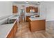 Functional kitchen featuring a center island, wooden cabinets, and white appliances for a seamless cooking experience at 5339 W Maldonado Rd, Laveen, AZ 85339