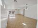 Spacious living area showcasing tile flooring, a ceiling fan, and abundant natural light from multiple windows at 5339 W Maldonado Rd, Laveen, AZ 85339