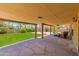 Spacious covered back patio with stone floor overlooking the manicured backyard at 5507 E Kings Ave, Scottsdale, AZ 85254