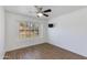 Bright bedroom with hardwood floors, fan and a window with plantation shutters at 5507 E Kings Ave, Scottsdale, AZ 85254