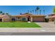 Charming single-story home with a well-maintained lawn and a two-car garage at 5507 E Kings Ave, Scottsdale, AZ 85254