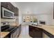 Open-concept kitchen featuring granite countertops, stainless appliances, connecting to the dining room at 5507 E Kings Ave, Scottsdale, AZ 85254