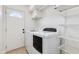 Clean laundry room with white appliances and storage shelves at 5507 E Kings Ave, Scottsdale, AZ 85254