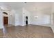 Open-concept living room with a modern chandelier, wood-look flooring and ample space at 5507 E Kings Ave, Scottsdale, AZ 85254