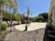 A beautiful backyard patio featuring lush landscaping and hardscape at 562 E Vesper Trl, Queen Creek, AZ 85140