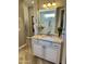 Bright bathroom vanity features a makeup mirror and spacious shower with clear glass doors at 562 E Vesper Trl, Queen Creek, AZ 85140
