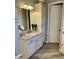 Bathroom featuring a vanity with granite countertops, mirror, and wood look flooring at 562 E Vesper Trl, Queen Creek, AZ 85140