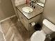 Compact bathroom features tile flooring, granite vanity, and a new toilet at 562 E Vesper Trl, Queen Creek, AZ 85140