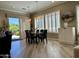 Dining room with views of the backyard, plenty of natural light, and attractive pendant lighting at 562 E Vesper Trl, Queen Creek, AZ 85140