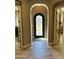 Foyer with decorative front door, tile floors, and arched doorway at 562 E Vesper Trl, Queen Creek, AZ 85140