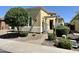 Inviting home with desert landscaping, decorative pergola over the entry, and lovely curb appeal at 562 E Vesper Trl, Queen Creek, AZ 85140