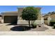 Inviting home with a well-manicured yard, mature tree, and a desert landscape at 562 E Vesper Trl, Queen Creek, AZ 85140