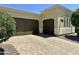 Exterior featuring a two-car garage and well-manicured landscaping at 562 E Vesper Trl, Queen Creek, AZ 85140