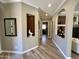 Hallway featuring an arched doorway, tile flooring, and decorative niches at 562 E Vesper Trl, Queen Creek, AZ 85140