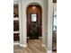 Hallway featuring a decorative cabinet and mirror in niche with hallway leading to kitchen at 562 E Vesper Trl, Queen Creek, AZ 85140