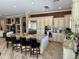 Open kitchen features an island with granite countertops, gas range, and stainless steel appliances at 562 E Vesper Trl, Queen Creek, AZ 85140