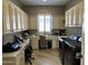 Well-appointed laundry room with custom cabinets and modern washer/dryer at 562 E Vesper Trl, Queen Creek, AZ 85140