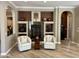 Cozy living room featuring a fireplace, built-in shelving, and comfortable seating at 562 E Vesper Trl, Queen Creek, AZ 85140