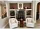Cozy living room featuring a fireplace, built-in shelving, and comfortable seating at 562 E Vesper Trl, Queen Creek, AZ 85140