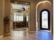 Open living room features a decorative front door and views to an elegant wine room at 562 E Vesper Trl, Queen Creek, AZ 85140