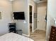 Main bedroom features a mounted TV and doorway view to the primary bath at 562 E Vesper Trl, Queen Creek, AZ 85140
