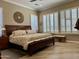 Comfortable primary bedroom with plantation shutters, wood flooring and ceiling fan at 562 E Vesper Trl, Queen Creek, AZ 85140