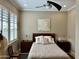 Relaxing main bedroom is bathed in light, with a ceiling fan and side tables at 562 E Vesper Trl, Queen Creek, AZ 85140