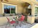 Inviting outdoor kitchen and dining area complete with stainless steel appliances and ample counter space at 562 E Vesper Trl, Queen Creek, AZ 85140