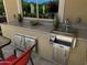 Modern outdoor kitchen with sink, counter, and stainless steel storage; a functional outdoor space at 562 E Vesper Trl, Queen Creek, AZ 85140