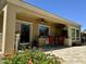 An inviting covered patio with outdoor kitchen, ceiling fan and a view of landscaped yard at 562 E Vesper Trl, Queen Creek, AZ 85140