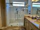 Bathroom featuring an updated tiled shower with glass door and shower head with bench at 562 E Vesper Trl, Queen Creek, AZ 85140