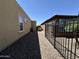 A narrow side yard featuring desert landscaping, offering a clean and low-maintenance design at 562 E Vesper Trl, Queen Creek, AZ 85140