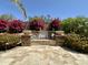 Beautiful backyard water feature with lush landscaping and colorful plants at 562 E Vesper Trl, Queen Creek, AZ 85140