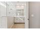 Bright bathroom featuring a dual vanity, wood-look floors, and tiled shower at 5827 E Covey Ln, Phoenix, AZ 85054