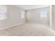 Neutral bedroom featuring plush carpeting, bright windows, and blinds for natural light and privacy at 5827 E Covey Ln, Phoenix, AZ 85054