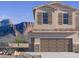 Two-story home showcasing a two-car garage and a stunning mountain view in the background at 5827 E Covey Ln, Phoenix, AZ 85054