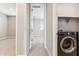 Hallway view leading to a bedroom, next to laundry closet with gray washer and dryer at 5827 E Covey Ln, Phoenix, AZ 85054