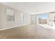 Spacious living room with wood-look tile, recessed lighting, and large windows, providing abundant natural light at 5827 E Covey Ln, Phoenix, AZ 85054