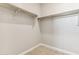 Empty walk-in closet featuring shelving and beige carpet at 5827 E Covey Ln, Phoenix, AZ 85054