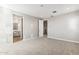 A bright bedroom features neutral walls, carpet, and access to an ensuite bathroom at 5843 E Covey Ln, Phoenix, AZ 85054