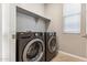 Laundry room features side-by-side washer and dryer and a window at 5843 E Covey Ln, Phoenix, AZ 85054